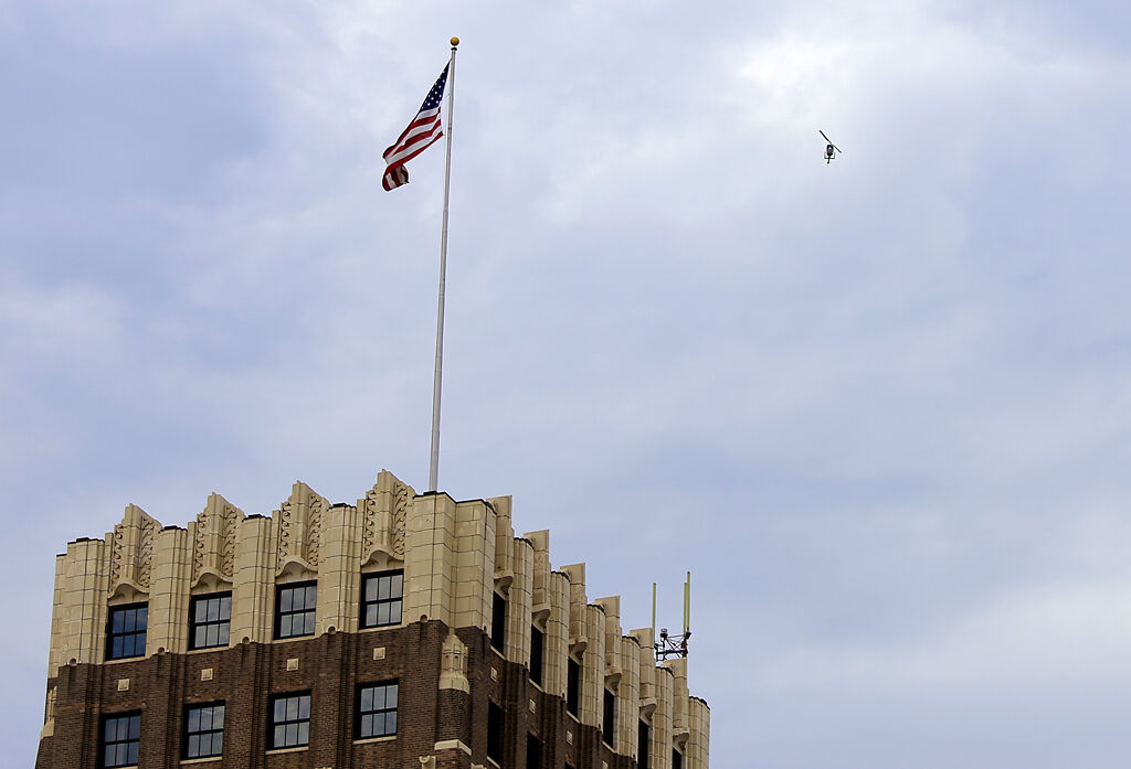 A police helicopter hovers over protesters Monday in St. Louis